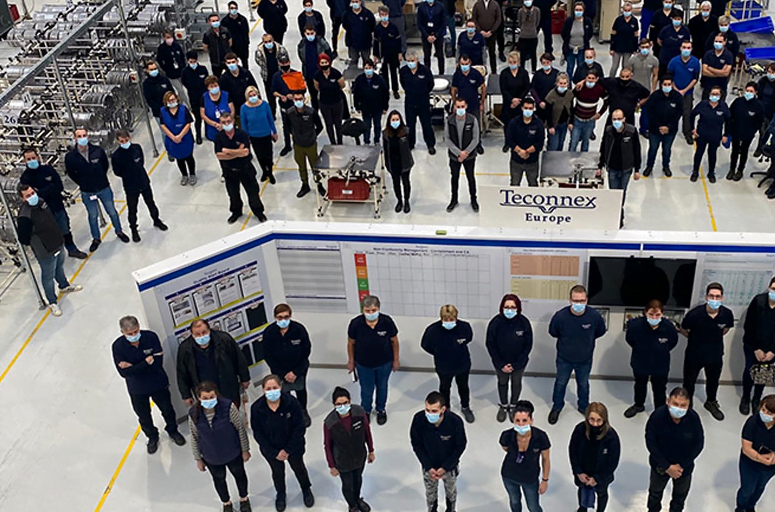 teconnex staff all looking up at camera in the factory